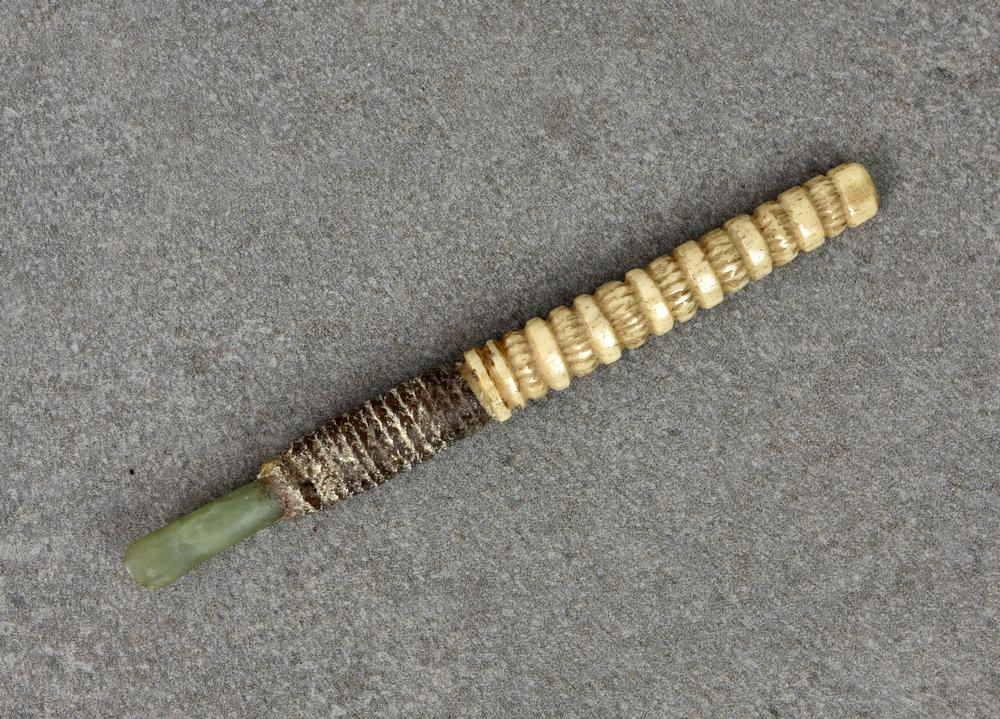 Auction comp thumbnail for Native tribal interest - A Maori Whao Pounamu (nephrite - jade) carving chisel having turned carved bone handle with nephrite blade... (Martel Maides, Lot 604)