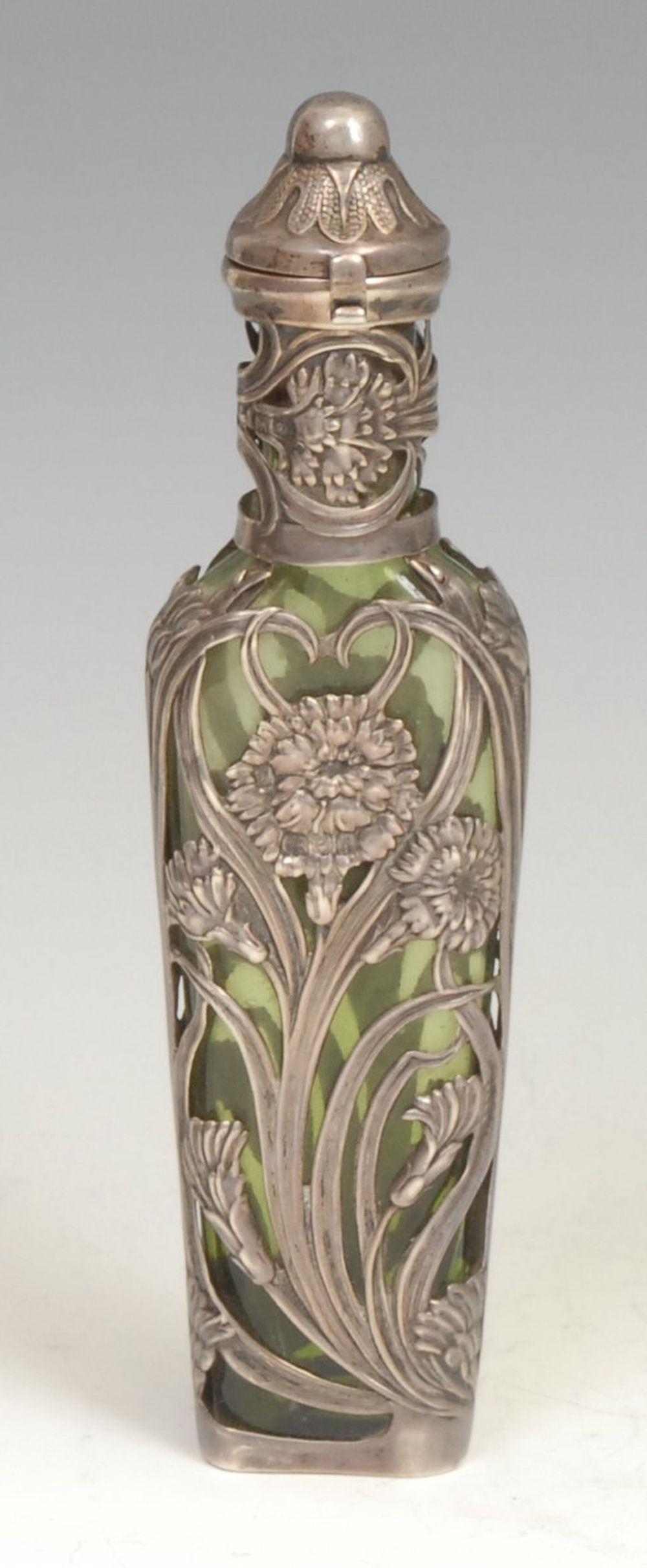 Auction comp thumbnail for An Art Nouveau silver and green glass scent bottle, the mount embossed with flowers and sinuous leaves, hinged cover enclosing a stopper, 16.5cm long, (Bamfords Auctioneers and Valuers Ltd, Lot 749)