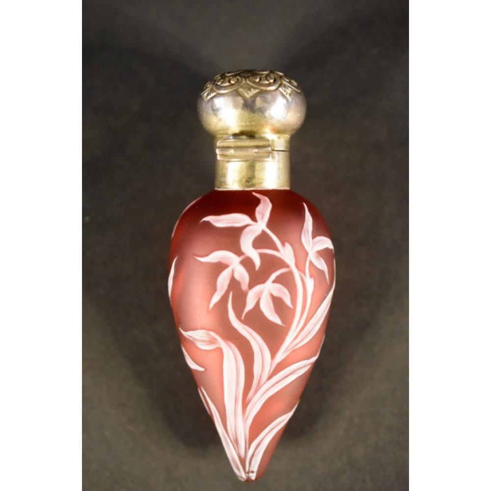 Auction comp thumbnail for Thomas Webb. A fine and rare cameo glass scent bottle having finely carved floral decoration. The Sterling silver lid having embossed floral decoration and original glass stopper. H 9.5cm, W 4cm (Christian McCann Auctions, Lot 818)