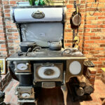 This is a vintage A. Belanger wood stove, boasting original features with rechromed metal, suggesting restoration efforts to maintain its integrity. It serves as a testament to craftsmanship from over half a century ago, merging utility with ornate design, likely dating back to the early 20th century.