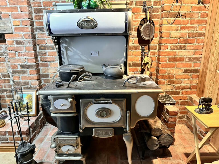This is a vintage A. Belanger wood stove, boasting original features with rechromed metal, suggesting restoration efforts to maintain its integrity. It serves as a testament to craftsmanship from over half a century ago, merging utility with ornate design, likely dating back to the early 20th century.