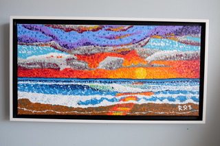 “Sunset Colors” is a vibrant 20″x10″ pointillist painting by Ron Sanford. A spectrum of fiery sunset hues is layered above the serene blues of the ocean, creating a dynamic contrast that’s heightened by the meticulous placement of acrylic dots, echoing the natural beauty of a day’s end by the sea.